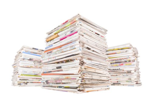 three-big-stacks-newspapers-isolated-white-background